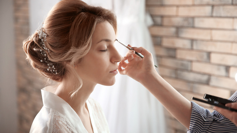 woman getting makeup done