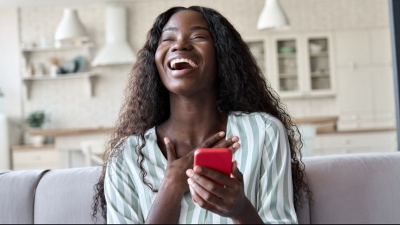 Woman smiling with cell phone