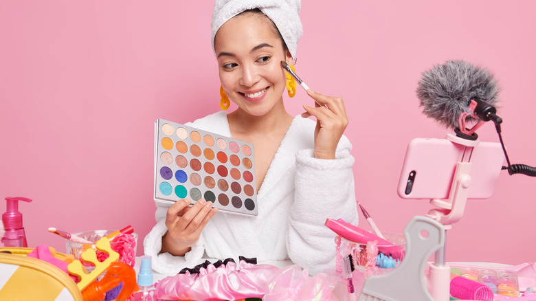 woman applying makeup