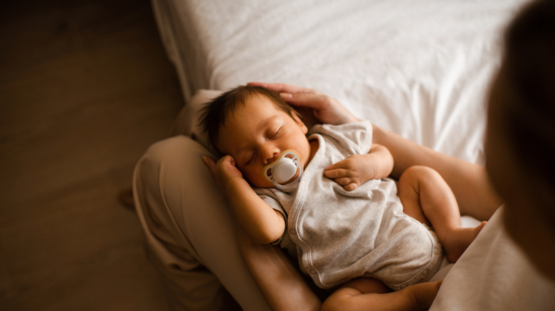 A newborn baby on someone's lap