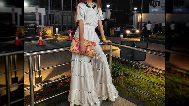 Woman wearing white shirt, skirt 
