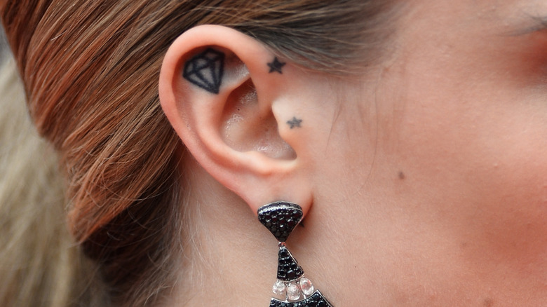 cara delevingne ear tattoo