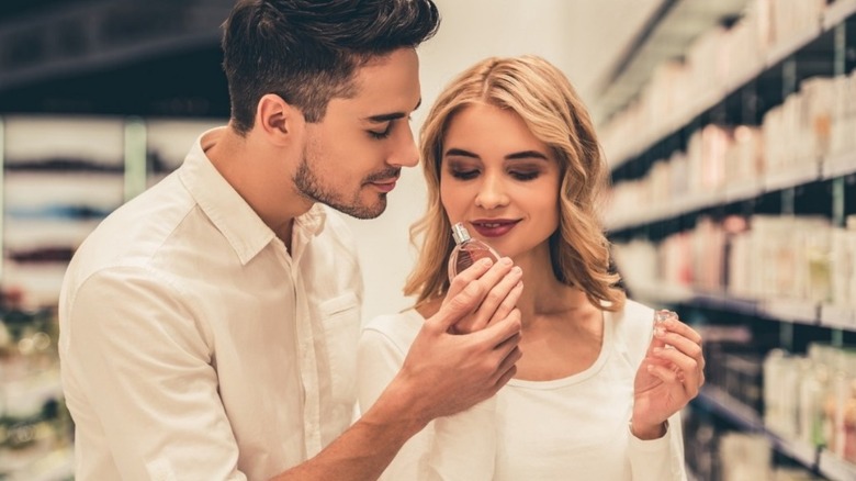 man and woman testing fragrance