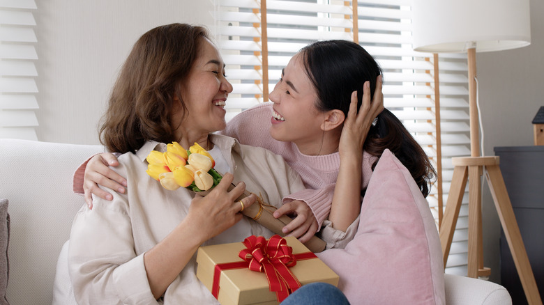 Woman giving gift to mother