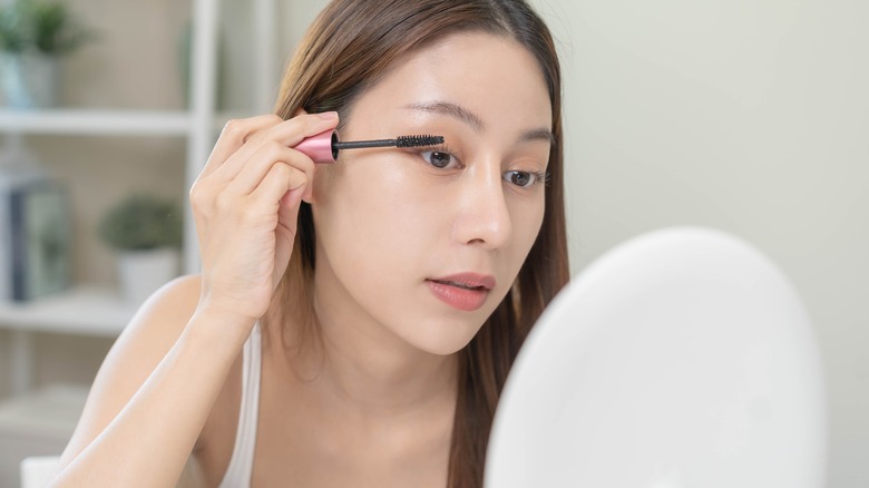 Girl putting on mascara