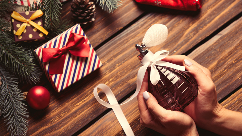 Person holding perfume