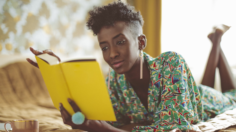 Person reading yellow book 