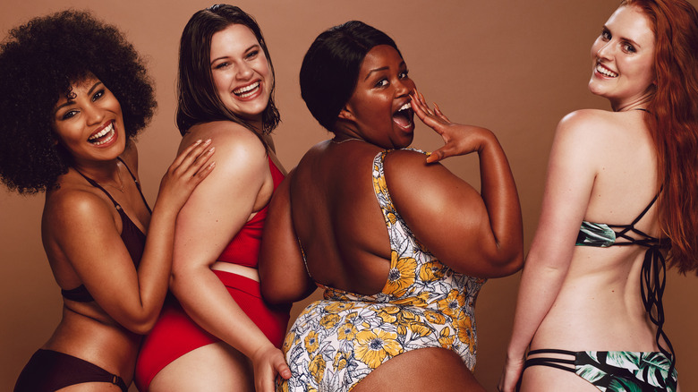 Group of smiling multicultural women in swimsuits.
