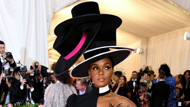 Janelle Monáe with large hat at gala