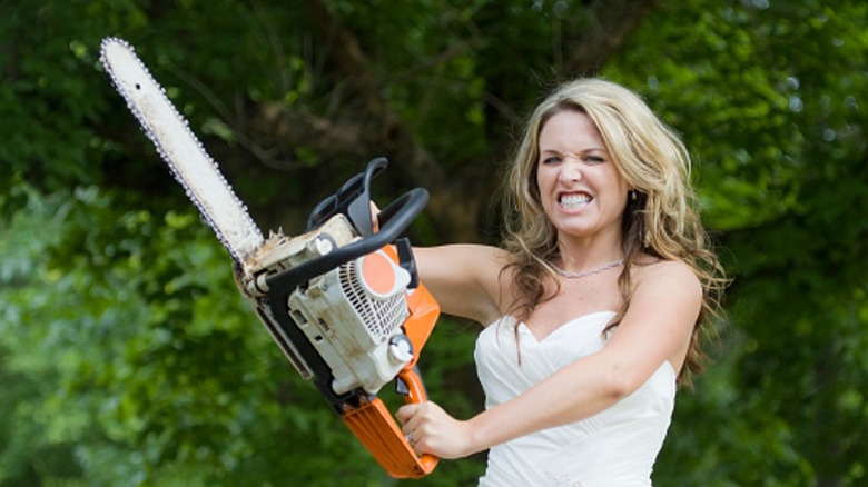 Angry bride holding chain saw