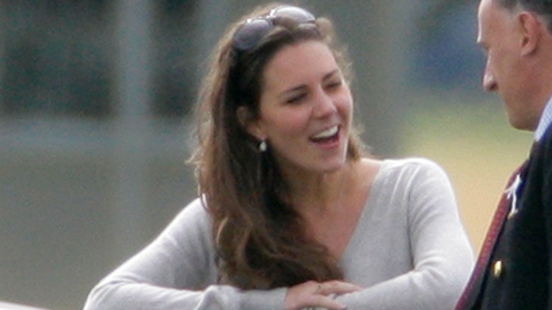 Kate Middleton talks to someone at a polo match