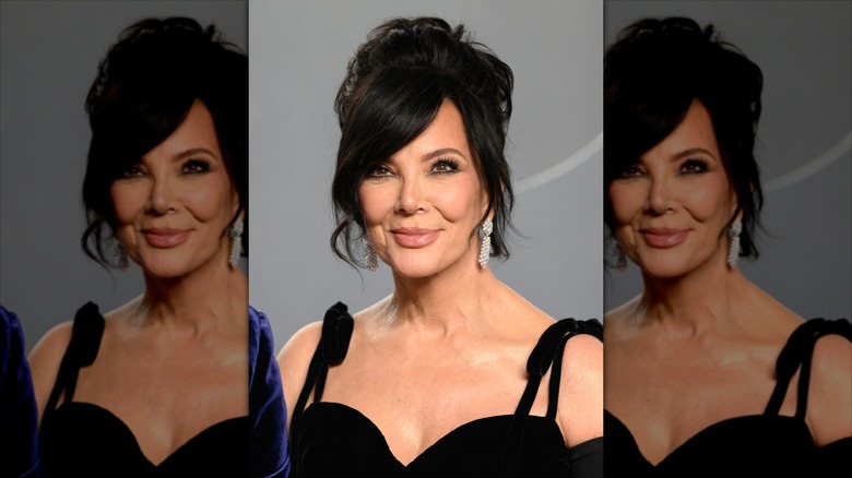 Kris Jenner smiles wearing a twisted updo