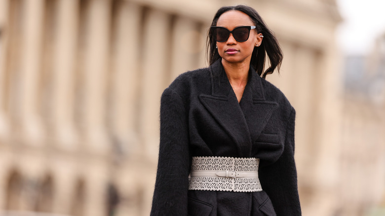 woman in coat with belt 