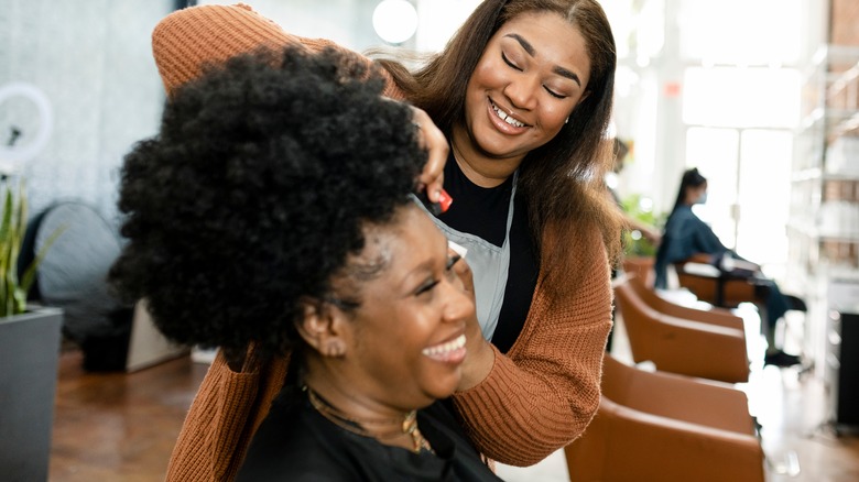 A hairstylist cutting her client's hair