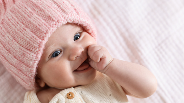 A baby wearing a pink beanie