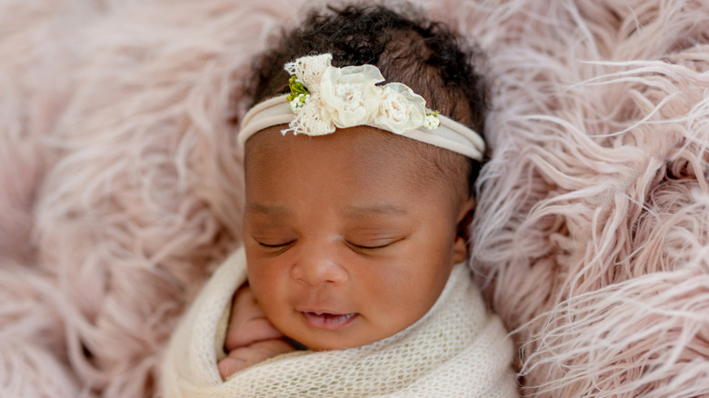 A baby girl sleeping in a blanket