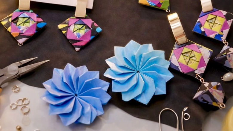 Paper jewelry strewn out on a crafting table