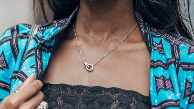 A woman wearing a minimalist necklace