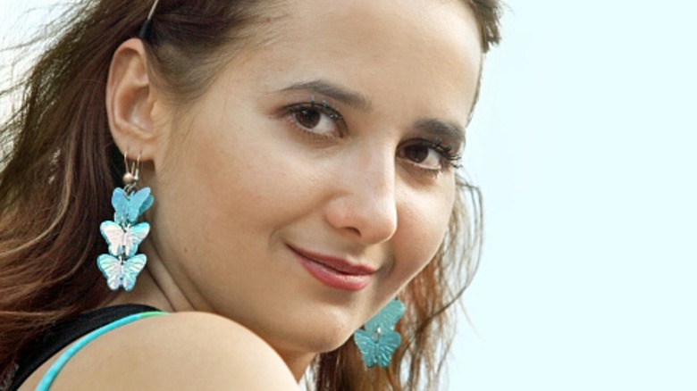 A woman wearing butterfly earrings