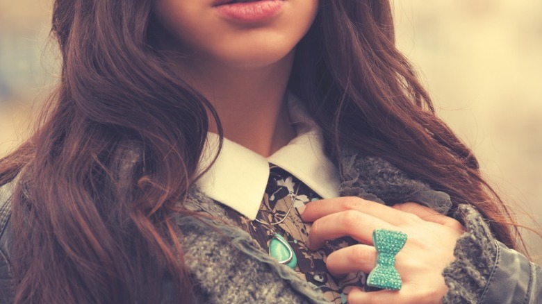 A woman wearing a bow ring