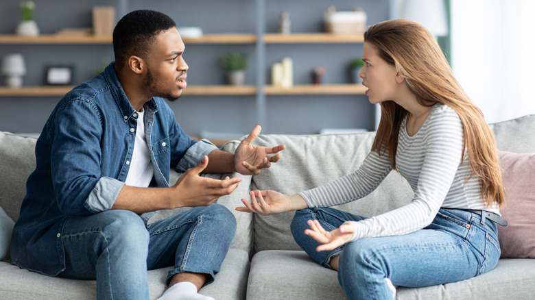 Couple arguing on couch