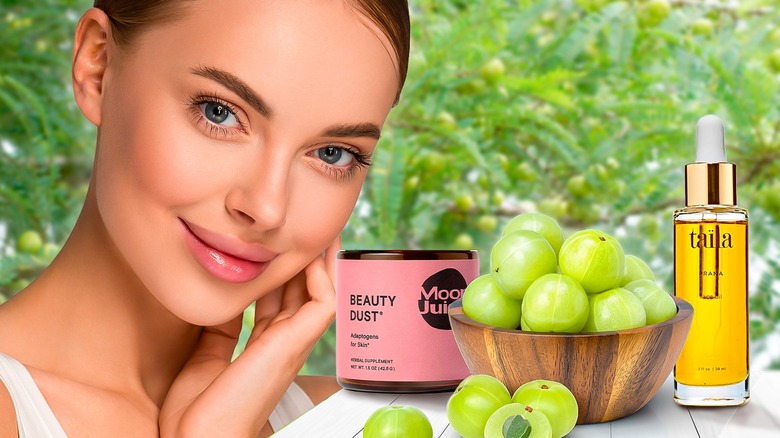 woman with amla fruit and products