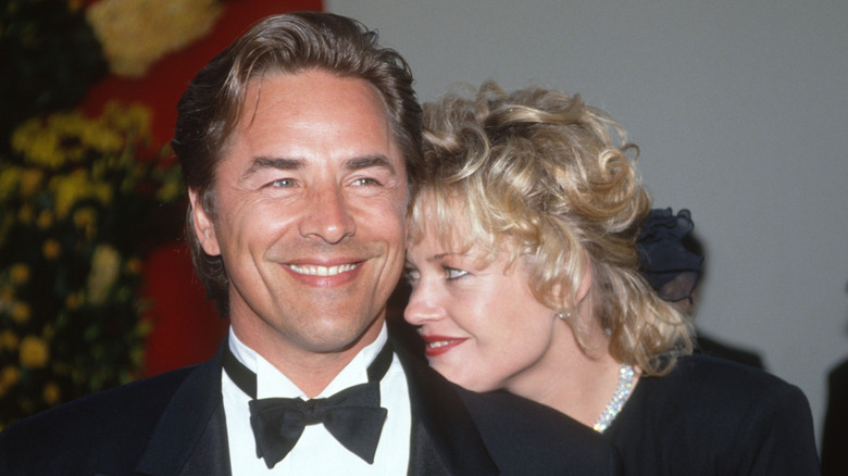 Don Johnson in a black tuxedo and Melanie Griffiths in a black dress at an event in 1989.