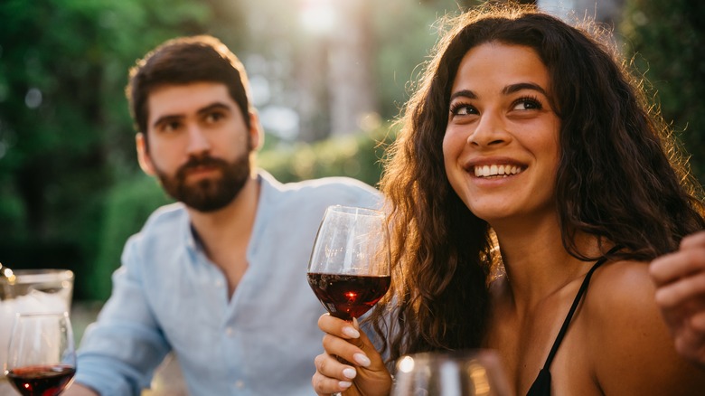 man and woman drinking wine