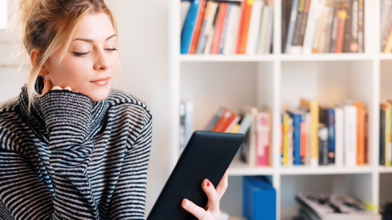 Woman reading Kindle 