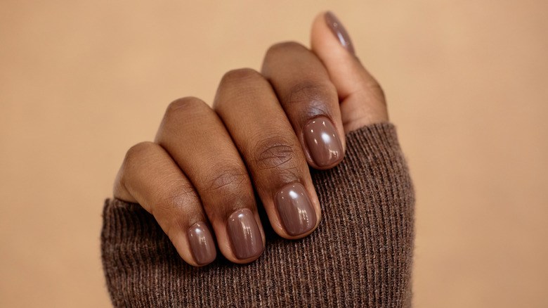 Close up shot of a brown nail polish manicure.