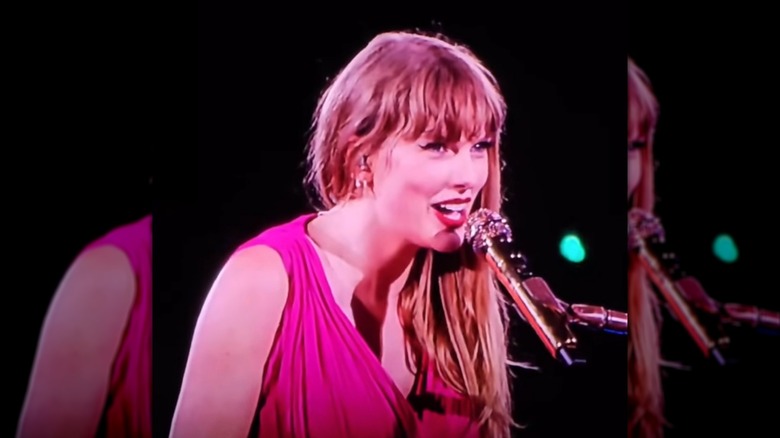Taylor Swift playing the piano and singing during the Eras Tour