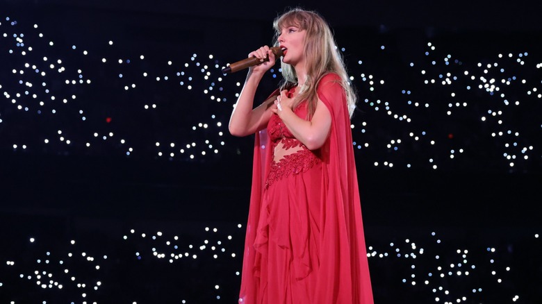 Taylor Swift performing in a red dress