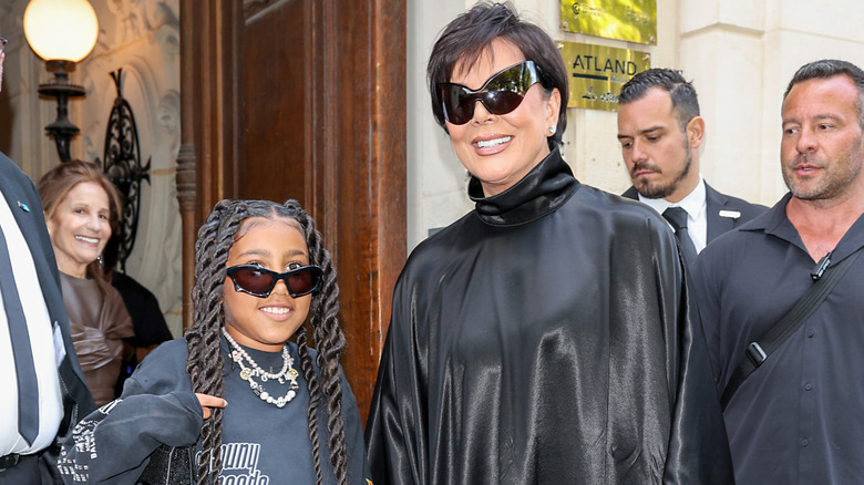 Kris Jenner and North West wearing sunglasses and smiling