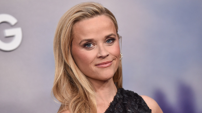 Reese Witherspoon smiles with a side parting