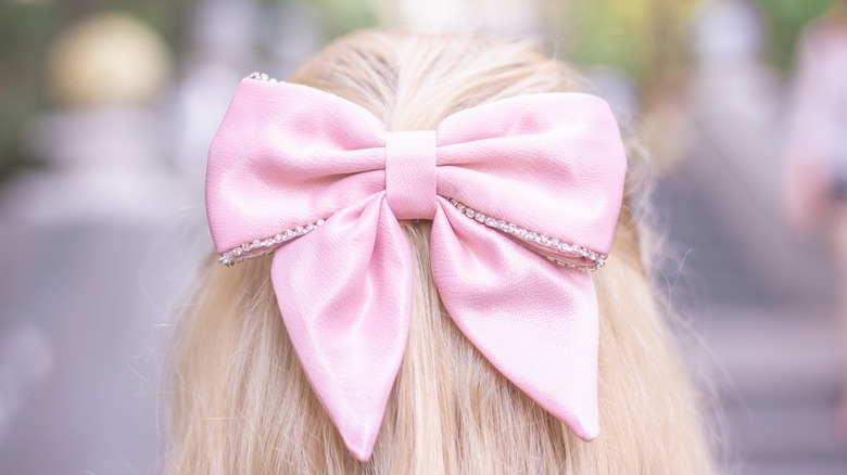 Blonde girl wearing pink bow 