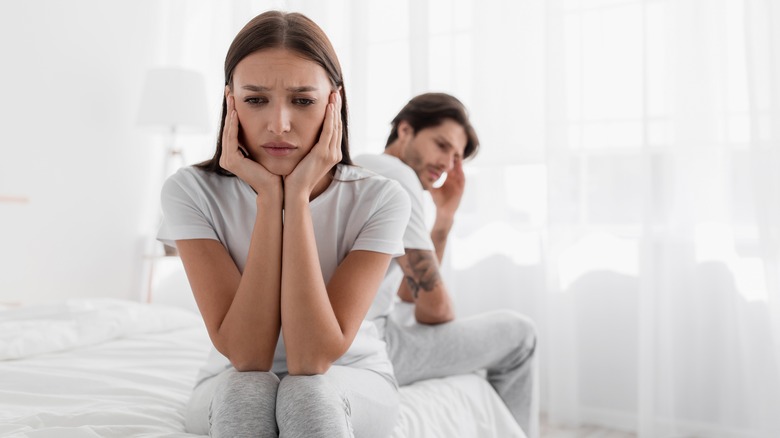 Couple fighting in bed