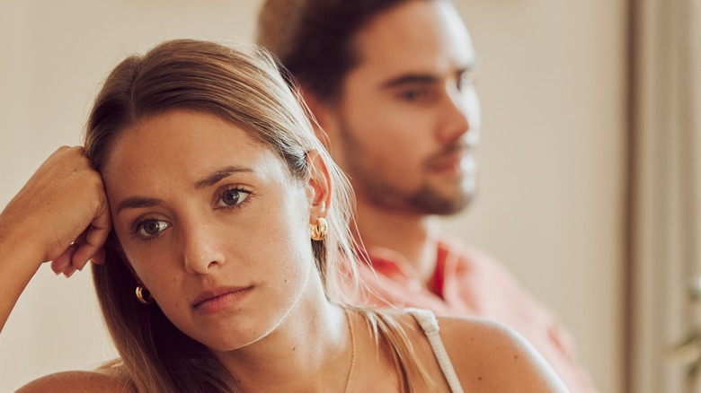 Couple arguing on couch 