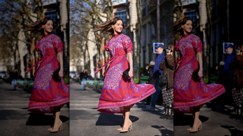 A woman in a pink floral dress with nude heels