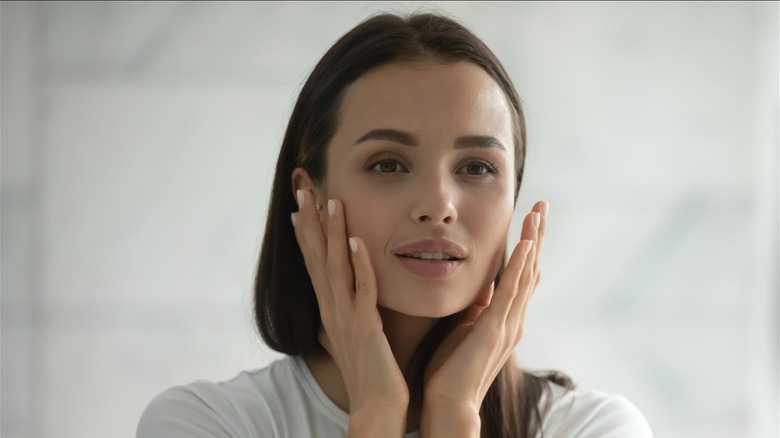 woman looking in mirror