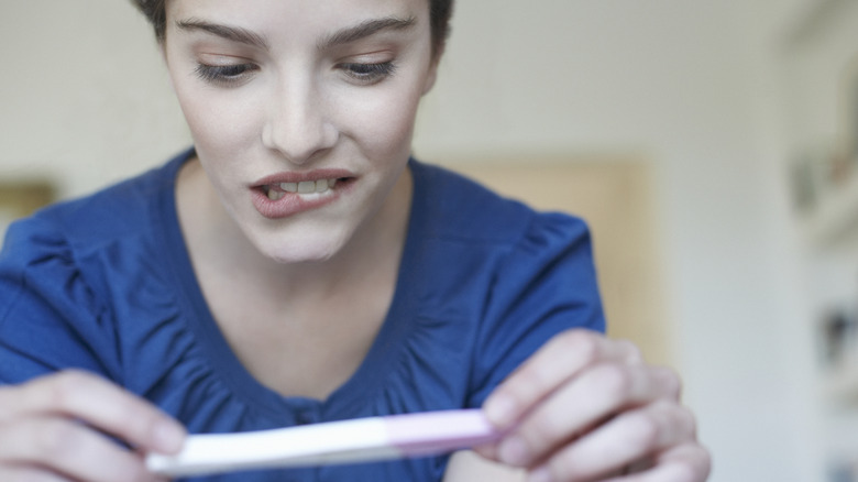 woman with pregnancy test