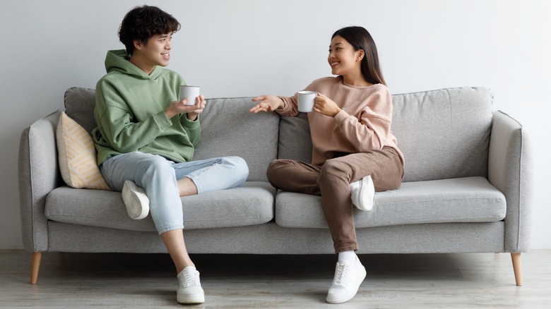 Two people speaking on couch