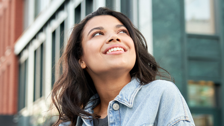 woman smiling on city steeet