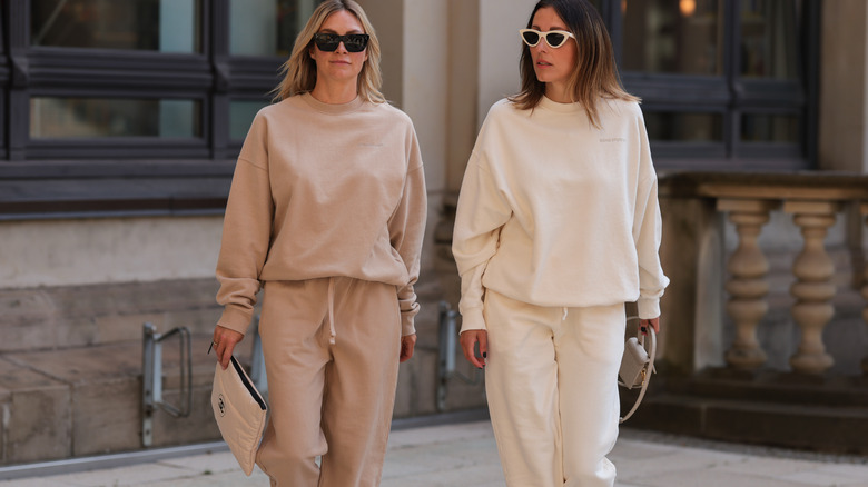 Two women wearing sweat suits