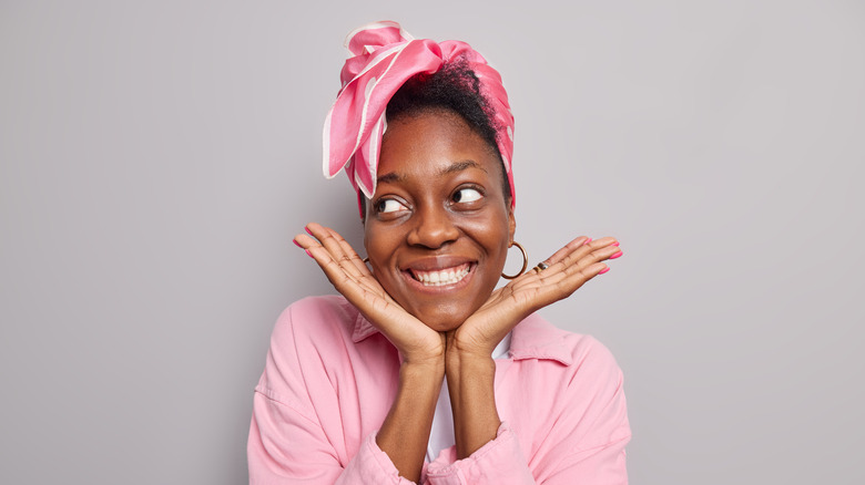 Woman smiling, showcasing face