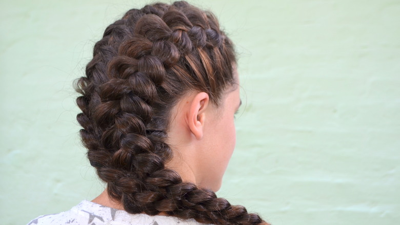 Woman models elaborate Dutch braids