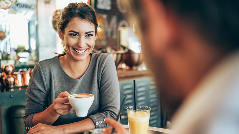 Smiling woman talking to man