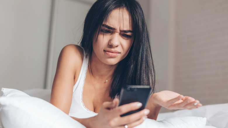 annoyed woman texting