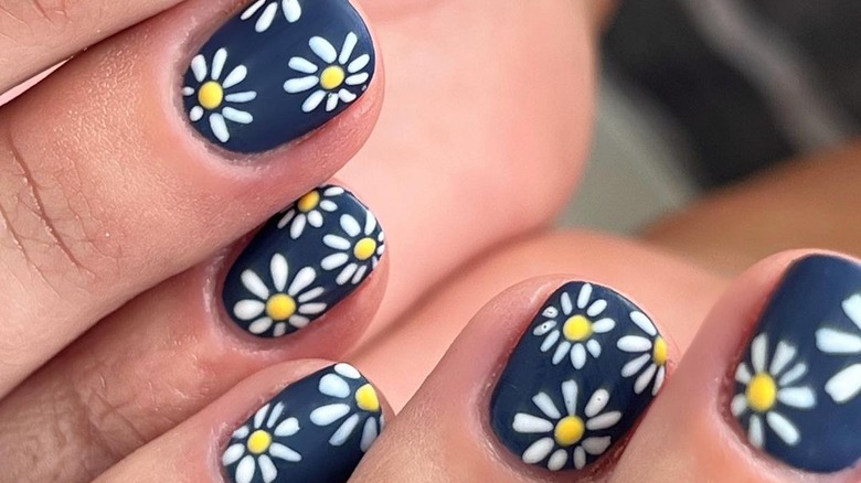 Navy nails with daisy accents