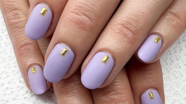 Purple matte nails with gold jewels