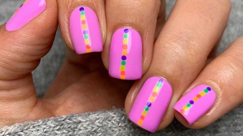 Bright pink nails and rainbow dots